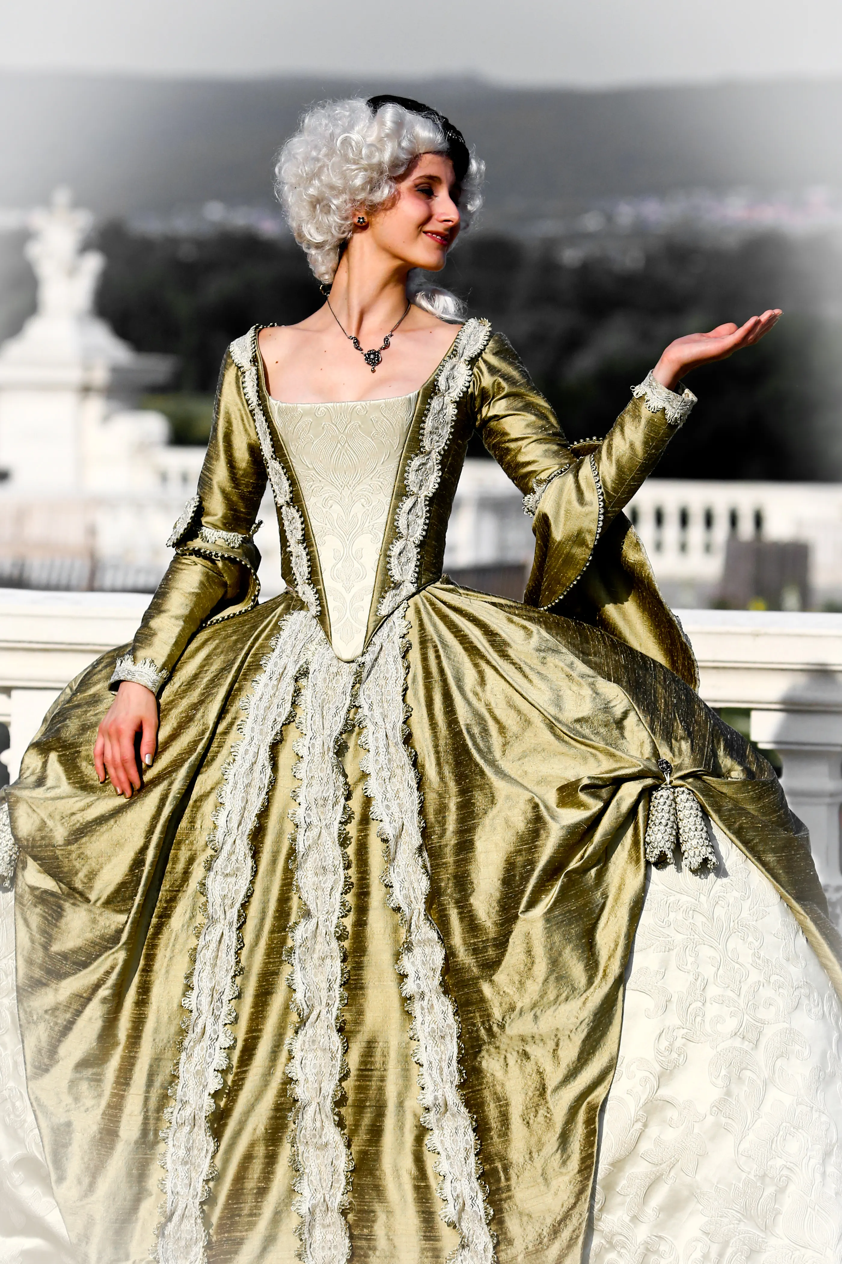 The reconstructed gown worn at Schloss Hof, its gold silk skirt spread over the wide panier, one hand raised