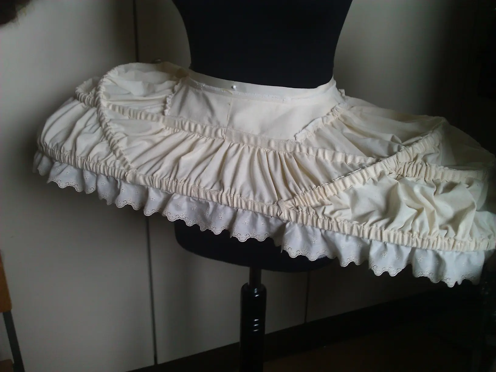 The oval panier with ruffled hoop casings standing on a dress form